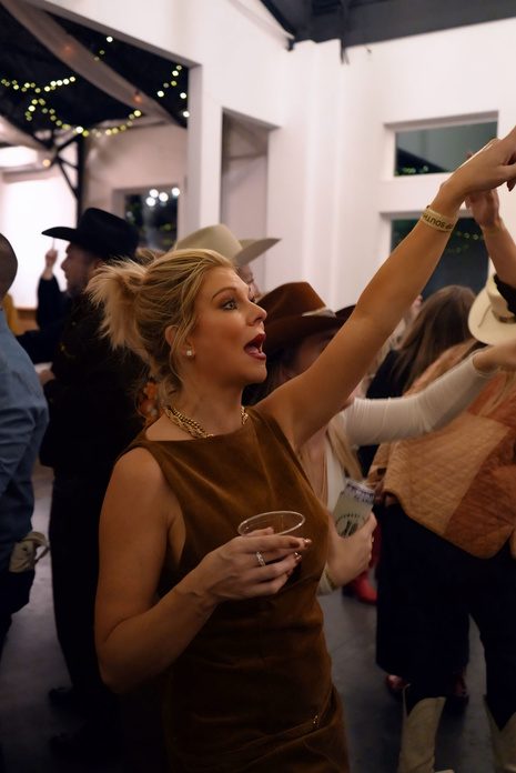 A guest dancing with her arm raised